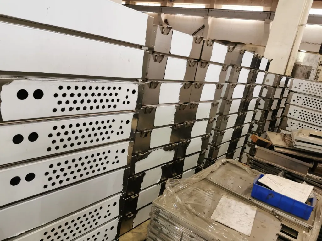 Custom sheet metal enclosure bracket with bent flanges and precision mounting holes, powder-coated gray finish