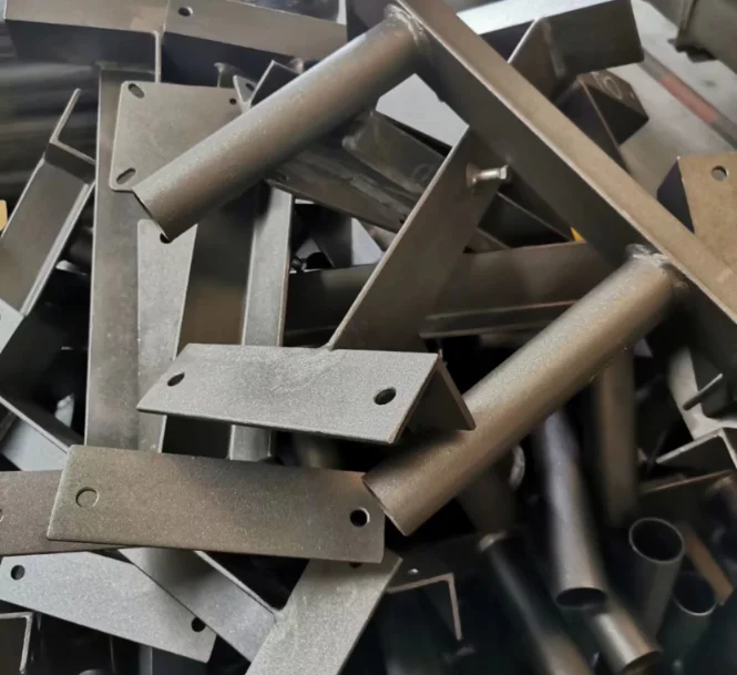 Welding fabricated steel brackets and metal components stacked after industrial welding and surface finishing process